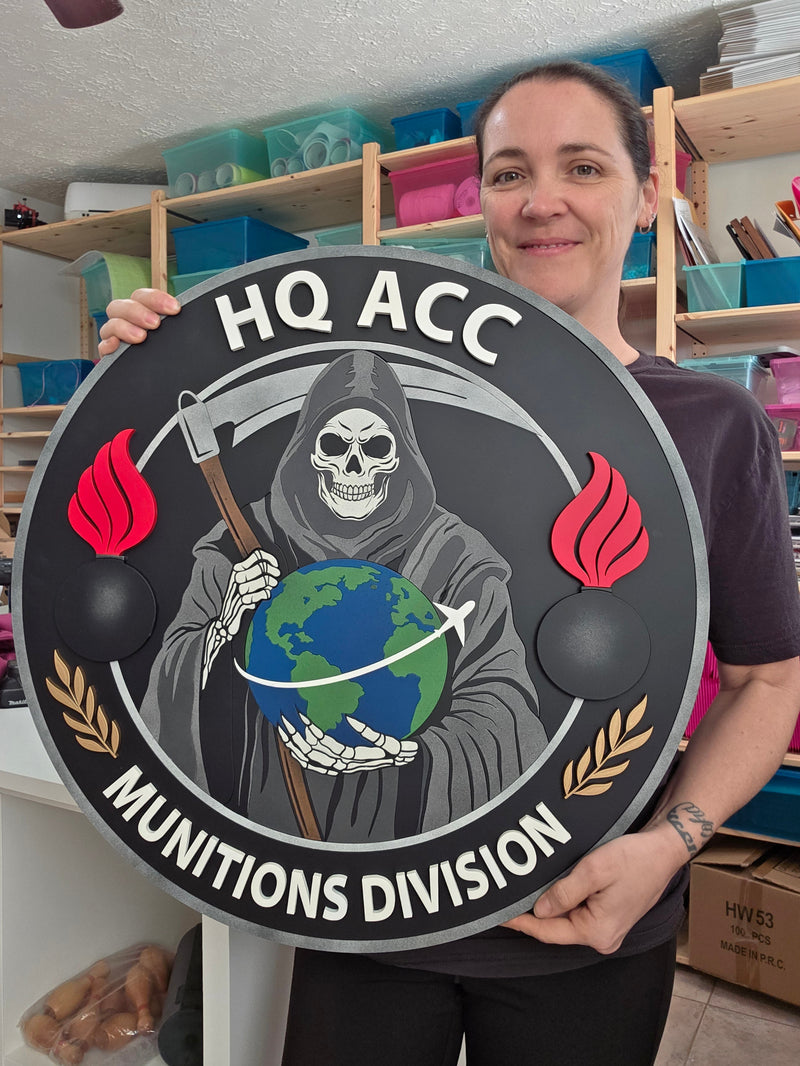 Person holding a circular sign with graphics and text in an indoor setting