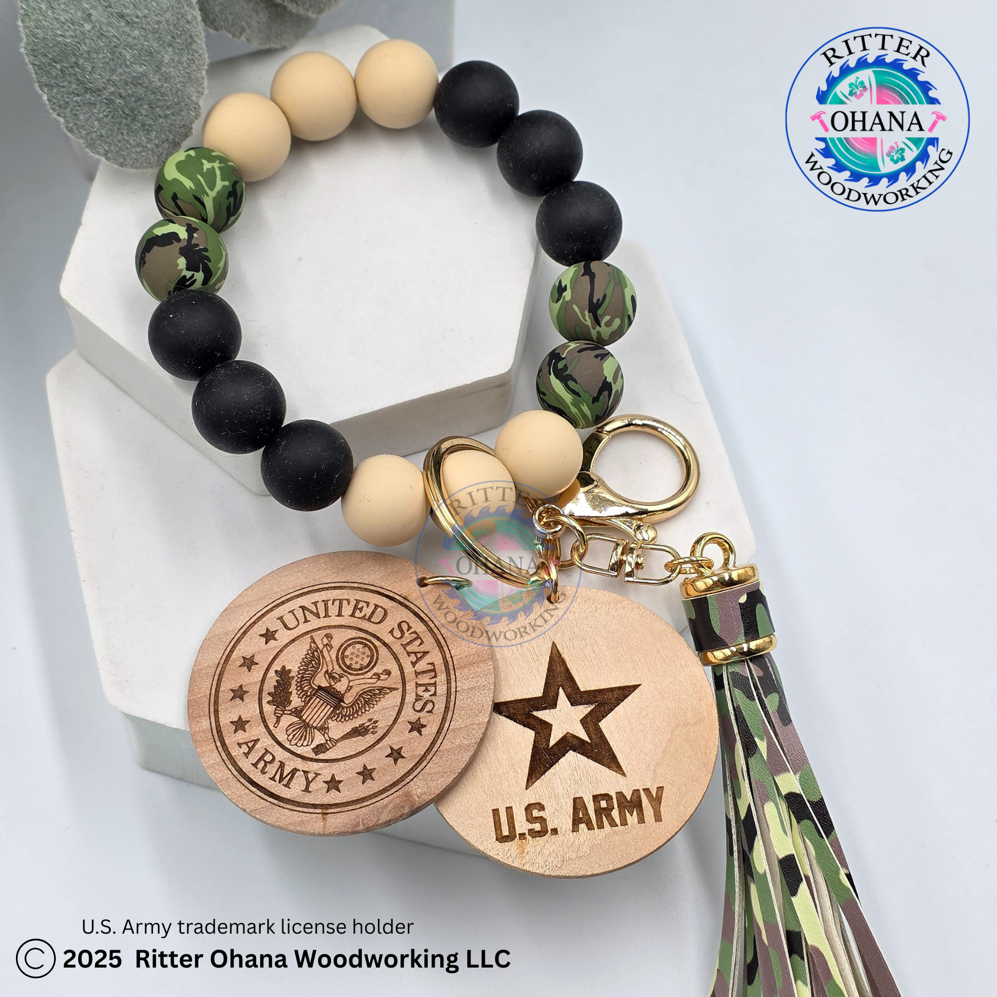 silicone beaded in tan, black and green camo  bracelet/ wristlets  with a tassel in camo design and round wooden disk with military logo engraded