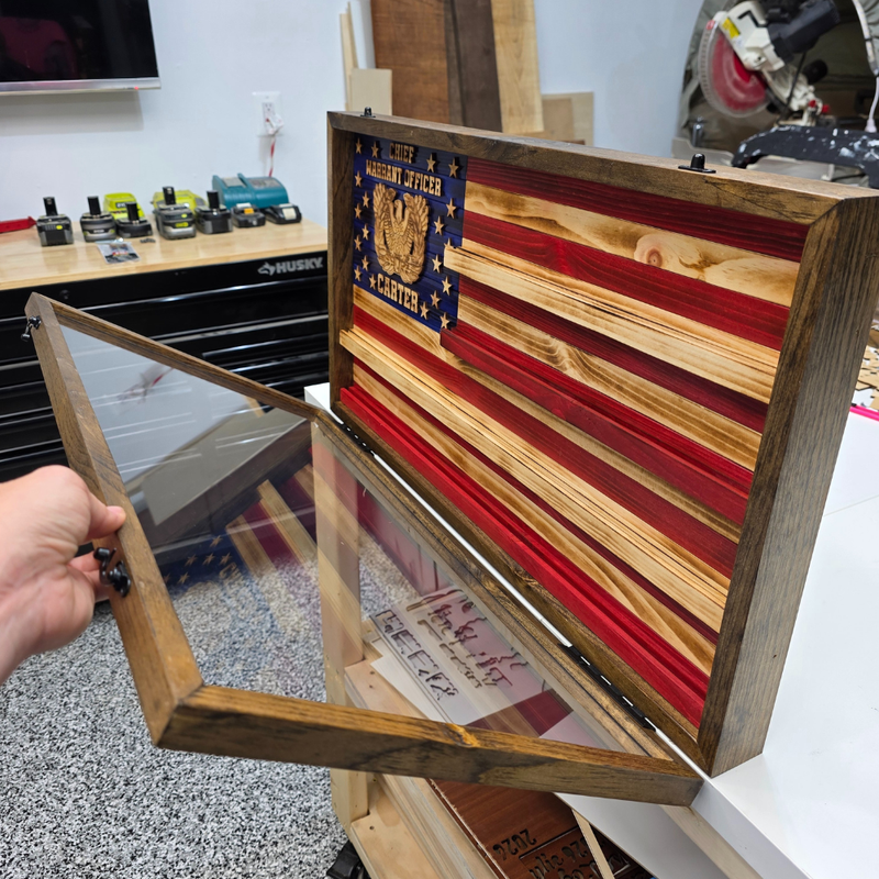 Wooden box with a flag design and American flag emblem, showing a clear front piece to keep dust out. 