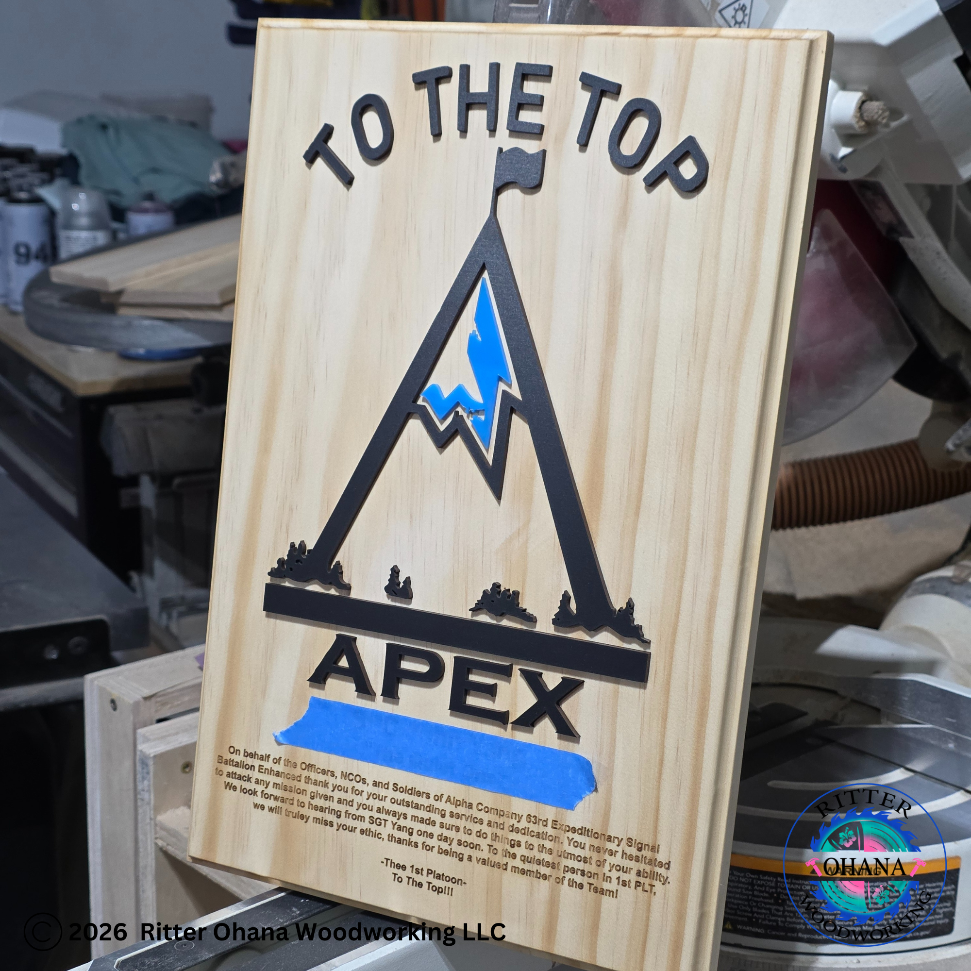 Wooden plaque with 'To the Top Apex' design and text engraved on the bottom. 