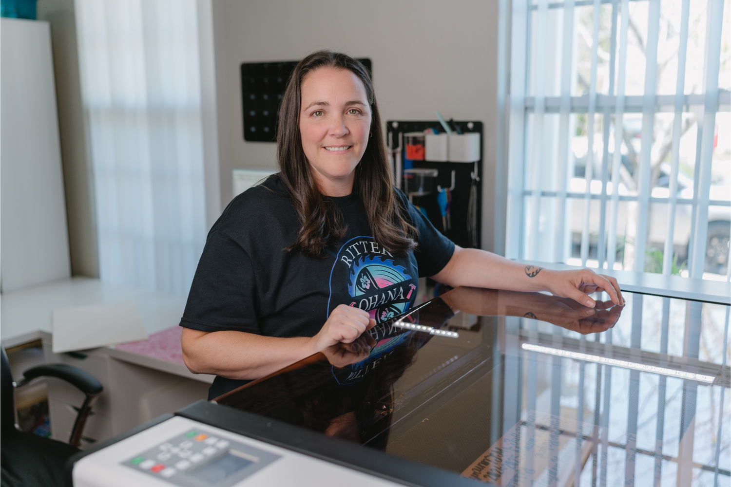 maker standing over a co2 laser. 