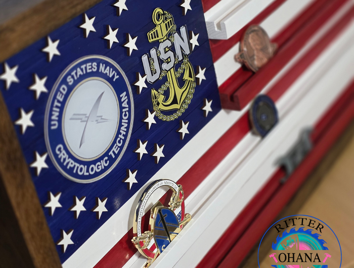 United States Navy flag with a crypto logic technician emblem on a wooden surface.