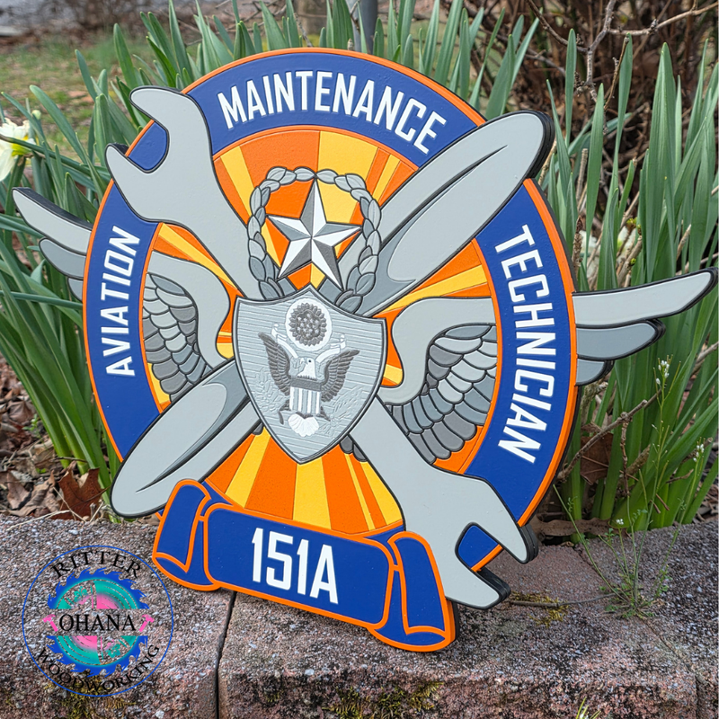 Logo for a Maintenance Technician with aviation symbols on a stone surface with plants in the background.
