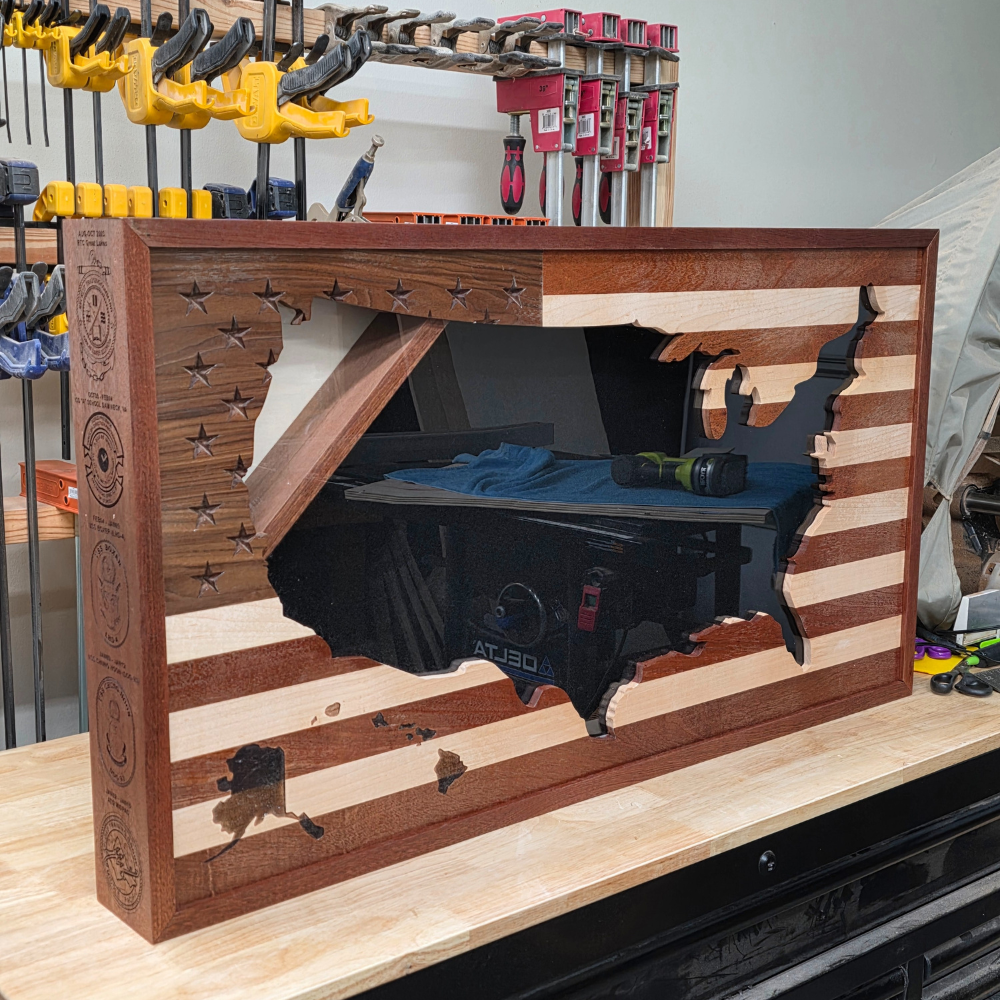Wooden workbench with wood shadow box wtih a flag cut out on the front and engraving of military unit logod