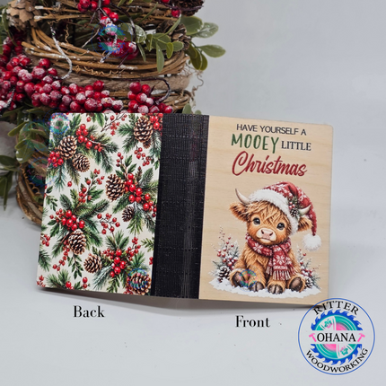 Wooden Christmas money and gift card holder with festive highland cow design on the front and holy and pine branch design on the back cover 